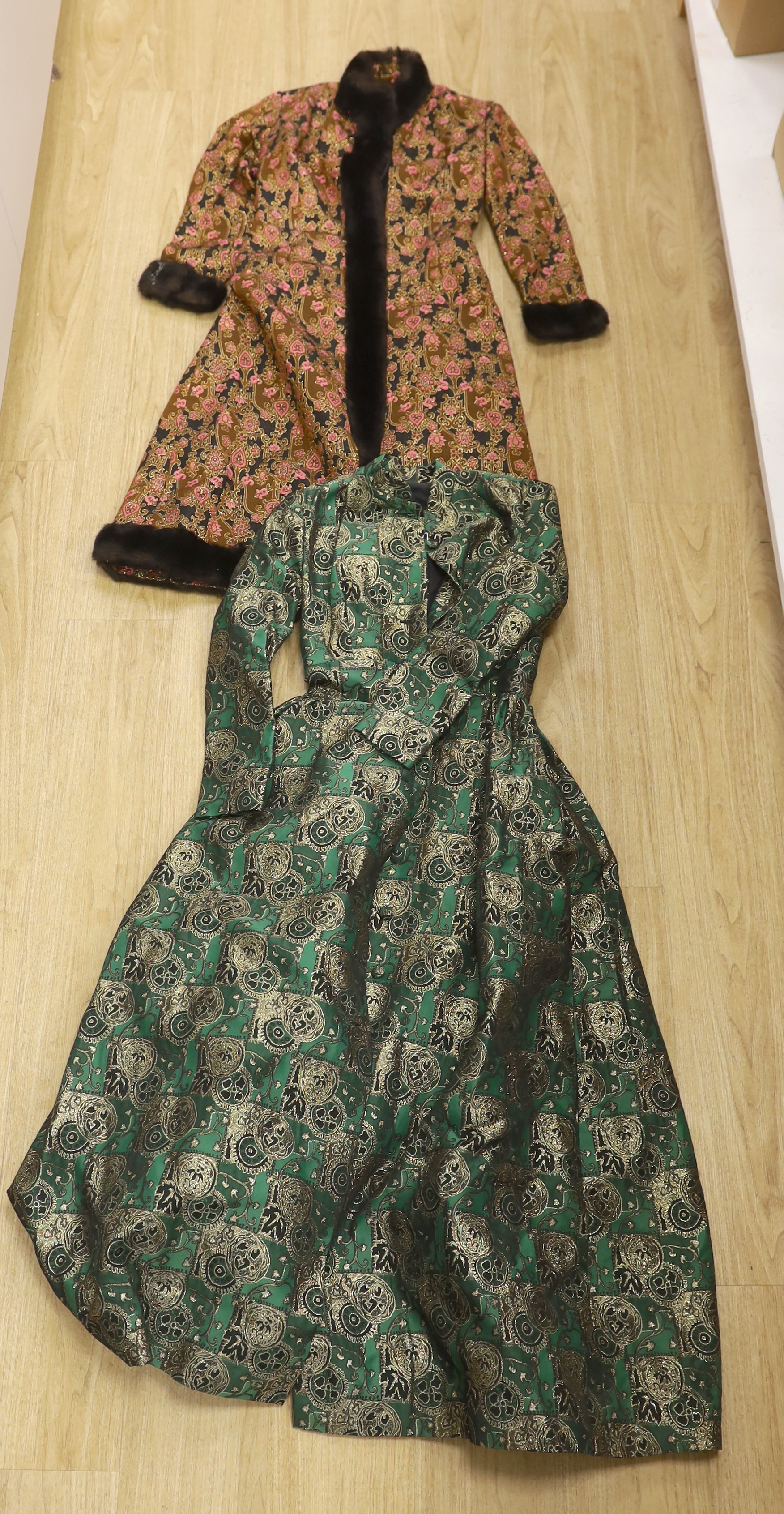 Two late 20th century brocade ladies evening coats, one with fur trimming to the neck, cuffs and bottom of coat